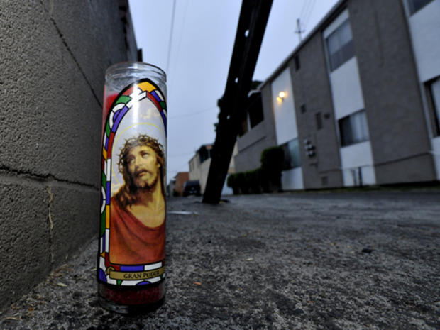 A memorial candle sits Wednesday morning, Aug. 19, 2009, in an alleyway outside the Buena Park, Calif., apartment complex where the body of a model missing from Los Angeles, Jasmine Fiore, 28, was placed in a dumpster. Buena Park police say they want to s 