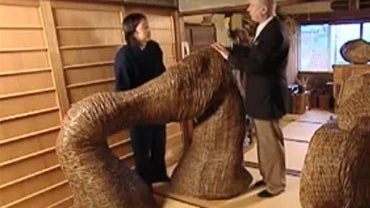Shochiko Tanabe shows <b>Barry Petersen</B> a piece of bamboo art he said represents connection. "This is the image of my father and my mother." 
