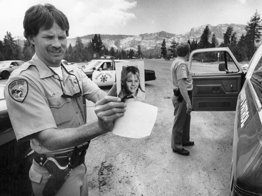 El Dorado county sherrif deputy holds missing sign 