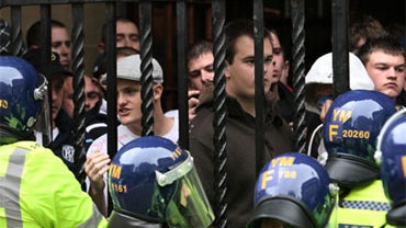 English Defence League demonstration.English Defence League supporters are herded into a pub entrance following a demonstration in Birmingham. 