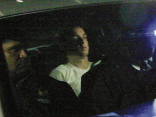 Raymond Clark III, 24, wearing white a T-shirt, is driven away from an apartment building by police on Tuesday Sept. 15, 2009 in Middletown, Conn. Police on Tuesday raided the apartment of Raymond Clark III, a man they call a person of interest in the sla 