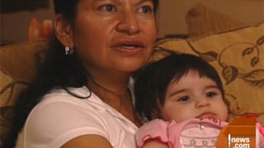 beatrice herhandez and daughter marylin, nine months, whom the ex-stripper claims was fahtered by Miami priest Father David Deubben 