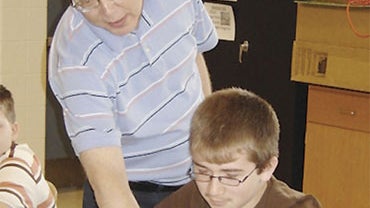 In this undated 2008 photo, Bill Sparkman is seen with 7th grade student, Jessie Roberts during a lesson about sound waves. 