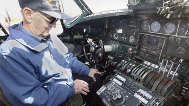 World War II pilot Bernerd Harding, 90, looks over the controls inside the cockpit of a B-24 in Laconia, N.H., Friday, Sept. 25, 2009. 