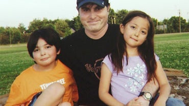 In this undated photo, Christopher Savoie poses with his children Isaac and Rebecca. 
