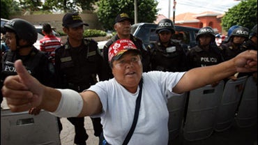 A supporter of ousted Honduras' President Manuel Zelaya protests in front of the U.S. embassy in Tegucigalpa, Friday, Oct 2, 2009. Interim President Roberto Micheletti said Monday, Oct. 5, 2009, that an emergency decree that limited civil rights in the tr 
