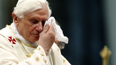 Pope Benedict XVI uses a handkerchief during a canonization ceremony at the Vatican Sunday, Oct. 11, 2009. 