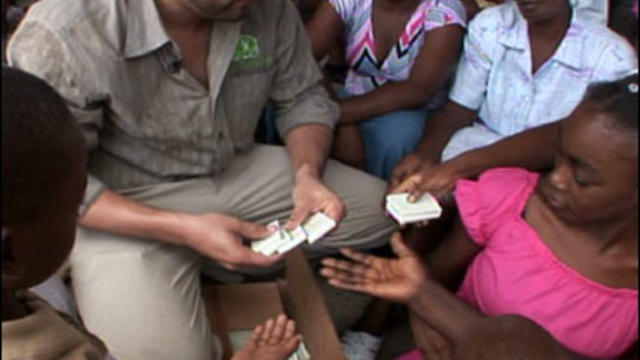 An employee for the non-profit organization Clean the World distributes little bars of soap to Haitians. The organization collects the slightly used bars from American hotels. This image came from an Evening News segment that ran on Monday, Oct. 12, 2009. 