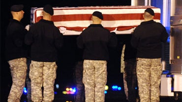 An Army carry team loads into a transfer vehicle a transfer case containing the remains of Army Staff Sgt. Glen H. Stivison Friday, Oct. 16, 2009 at Dover Air Force Base, Del. 