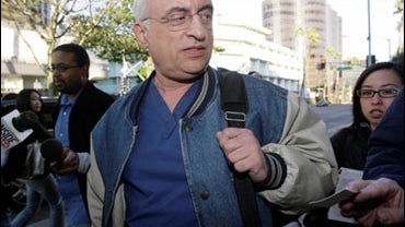 Followed by news reporters Dr. Michael Kamrava, 57, leaves his Beverly Hills, Calif. office on Monday, Feb. 9, 2009. Kamrava's name emerged Monday as a result of an interview aired Monday on NBC with Nadya Suleman, who gave birth to eight babies Jan. 26.  