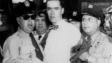In this Sept. 6, 1949 picture, Howard Unruh, center, is shown with police after his capture in Camden, N.J. Unruh committed a mass murder the day before, gunning down 13 people, in an era when such killings were still rare. On Monday, Oct. 19, 2009, Camde 