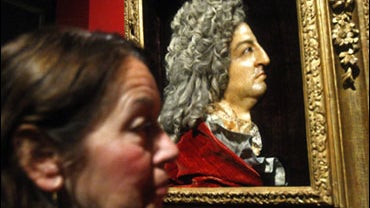 A visitor looks at a relief wax portrait of King Louis XIV, by Antoine Benoist, at the exhibition "Louis XIV, the man and the king"at the Chateau de Versailles, west of Paris, Monday, Oct. 19, 2009. The exhibition brings together more than 300 exceptional 