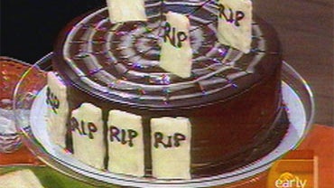 A ghoulish treat for a Halloween party: a Spider Web Cake decorated with tombstones (graham crackers dipped in white chocolate), prepared by Food & Wine magazine's Grace Parisi on "The Early Show Saturday Edition," Oct. 24, 2009. 
