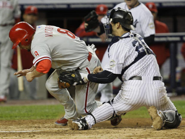 New York Yankees catcher Jorge Posada tags out Philadelphia Phillies' Shane Victorino 