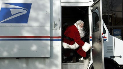 A U.S. Postal worker dressed as Santa Claus sits in his truck in Washington, D.C., in this 2004 file photo. 