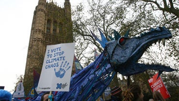 Climate change protestors form a human wave around the Houses of Parliament in central London Saturday, Dec. 5, 2009, as tens of thousands of people join in demonstrations calling for action on climate change ahead of crunch U.N. talks in Copenhagen. Worl 