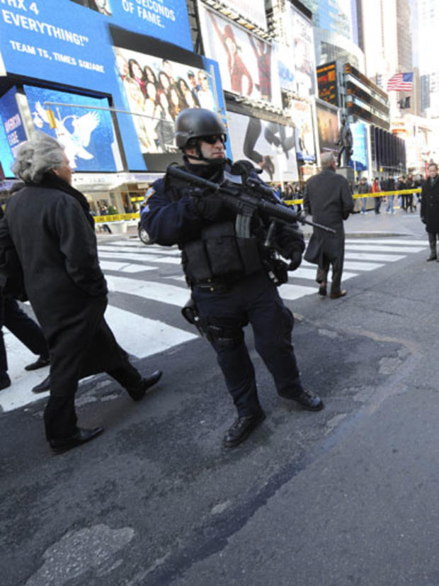 SLIDESHOW - Police officers guard a cordoned off area around the Marriot Marquis Hotel in Times Square where a shooting took place, Thursday, Dec.10, 2009, in New York. 