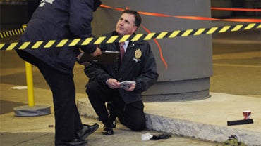 A bullet hole is seen in a shattered window of a souvenir shop in the parking garage of the Marriot Marquis Hotel in Times Square where a shooting took place, Thursday, Dec.10, 2009, in New York. (AP Photo/Louis Lanzano) 