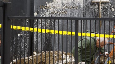 Police investigate the grave of former Cyprus President Tassos Papadopoulos at a cemetery in Deftera suburb of Nicosia, Cyprus, Friday, Dec. 11, 2009. 
