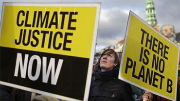 A protestor carries placard reading "There is no Planet B" as she joins a rally outside the Danish parliament in the center of Copenhagen, Denmark, Saturday, Dec. 12, 2009. 