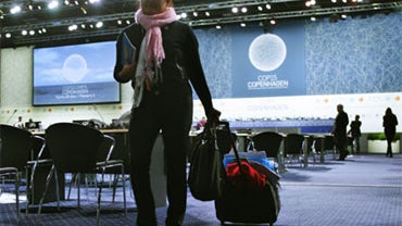An unidentified delegate leaves the plenary after the UN Climate Summit finished in Copenhagen on Saturday, Dec. 19, 2009. 