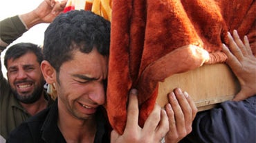Mourners carry the coffin of Nasser Ali, 22, during his funeral procession in Baghdad, Iraq, Thursday, Dec, 24, 2009. 