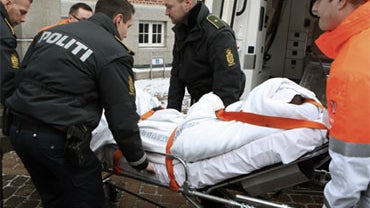 A man charged with the attempted murder of Danish cartoonist Kurt Westergaard is carried into court on a stretcher in Aarhus, Denmark, Saturday, Jan. 2, 2010. 
