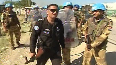 UN security team confronts a crowd of Haitian men seeking jobs. 