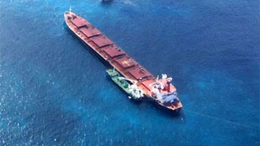 The bulk carrier Shen Neng 1, aground on the Great Barrier Reef 70 kilometers east of Great Keppel Island, show during operations to refloat the ship after salvage crews pumped heavy fuel oil off the stricken vessel, Monday, April 12, 2010.  