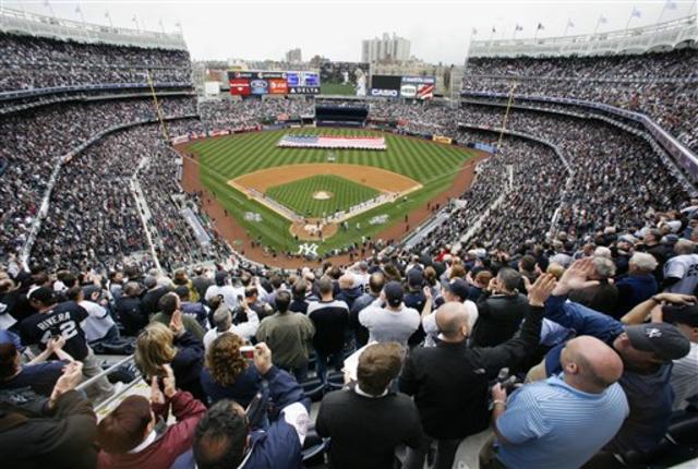 Joe Girardi, Yogi Berra and Whitey Ford watch New York Yankees Derek Jeter  receive his World Series championship ring before playing the Los Angeles  Angels of Anaheim on opening day at Yankee