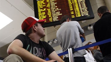 Matt Cowley of Melbourne, Australia waits to talk to an agent at the British Airways counter at Los Angeles International Airport on Saturday, April 17, 2010. 