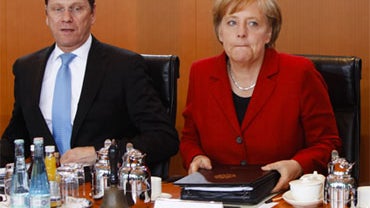 German Chanceller Angela Merkel, right, and Foreign Minister Guido Westerwelle arrive for a special cabinet meeting to provide Greece with billions of euros in aid as part of an EU bailout plan at the chancellery in Berlin, Monday, May 3, 2010. 