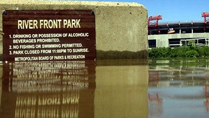 A sign for Riverfront Park is visible as floodwaters from the Cumberland River recede on Tuesday, May 4, 2010 in Nashville, Tenn. LP Field, home of the Tennessee Titans, is visible across the river. The Cumberland River that submerged parts of Music City' 