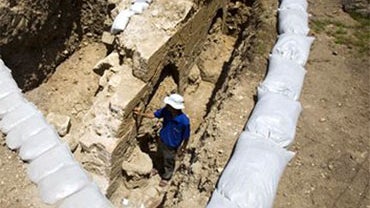 Israeli archaeologist Yahiel Zelinger, shows a section of the 14th-century aqueduct near Jerusalem's Old City, Tuesday May 11, 2010. Archeologists say they have uncovered a 14th-century aqueduct that supplied water to Jerusalem for almost 600 years. But u 