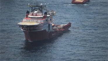 A ship assists in cleanup efforts in the vicinity of the source of the Gulf of Mexico oil spill, May 13, 2010. 