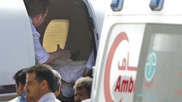A stretcher carrying Ruben van Assouw is see inside a Libyan air ambulance as it prepares to leave Tripoli's Matiga airport, Libya Saturday, May 15, 2010. 