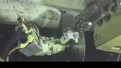 An underwater camera captures operations to cut the broken riser pipe at the site of the Deepwater Horizon drilling rig in the Gulf of Mexico, Tuesday, June 1, 2010. 
