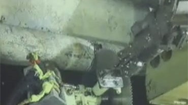 An underwater camera captures operations to cut the broken riser pipe at the site of the Deepwater Horizon drilling rig in the Gulf of Mexico, Tuesday, June 1, 2010. 