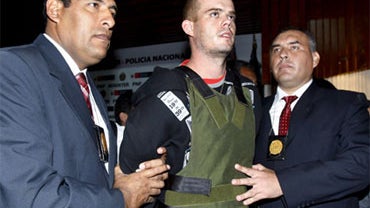Police officers escort Joran Van der Sloot, second right, during a press conference at a police station in Lima, Saturday, June 5, 2010. 