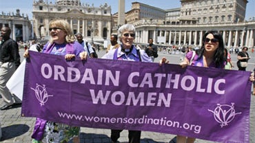 Representatives of the Women's Ordination Conference stage a protest in front of St. Peter's Basilica in Rome on Tuesday, June 8, 2010. Holding the poster, from left: Therese Koturbash from Dauphin, Manitoba, Canada; Mary Ann Schoettly from Newton, N.J.;  