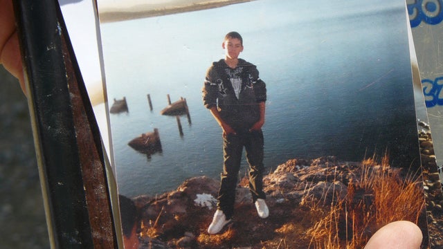 An unidentified relative shows a photo of Sergio Adrian Hernandez Huereka, 15, to the press outside his mother's home in the northern border city of Ciudad Juarez, Mexico, June 8, 2010. 