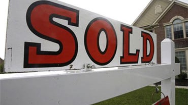 In this June 2, 2010 photo, a sold sign is posted outside a home, in Cincinnati. Rates on 30-year fixed mortgages fell this week to the lowest level of the year and were barely shy of the all-time low.(AP Photo/Al Behrman) 