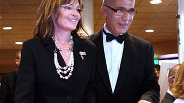 Former Republican vice presidential candidate Sarah Palin is escorted into a fundraising dinner by California State University, Stanislaus President Hamid Shirvani in Turlock, Calif., Friday, June 25, 2010. Palin's speech has generated intense scrutiny si 