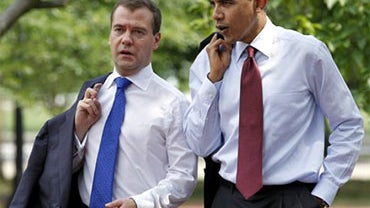 In a Thursday, June 24, 2010 photo, President Barack Obama and Russian President Dmitry Medvedev walk through Lafayette Park in Washington. The FBI announced Monday the arrests of 10 alleged deep-cover Russian agents after tracking the suspects for years. 