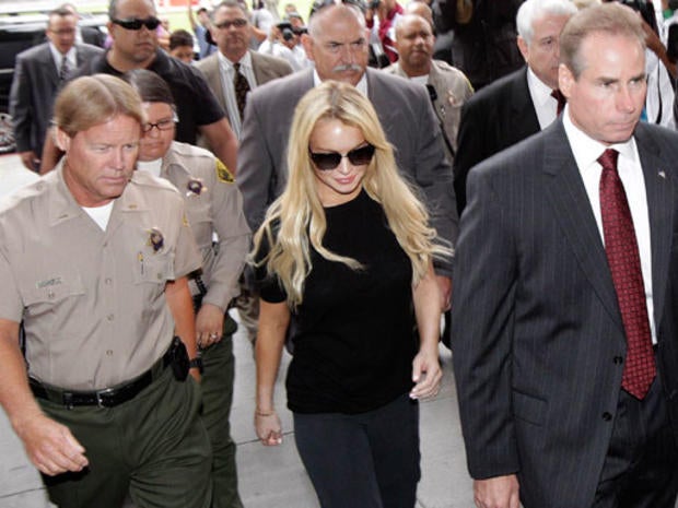 Actress Lindsay Lohan, center, arrives at Beverly Hills courthouse in Beverly Hills, Calif., Tuesday, July 6, 2010. 