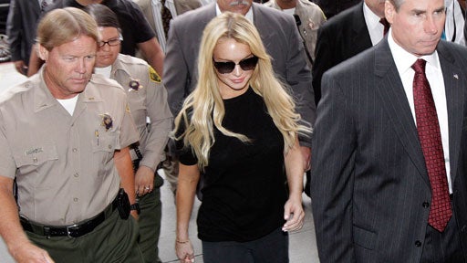 Actress Lindsay Lohan, center, arrives at Beverly Hills courthouse in Beverly Hills, Calif., Tuesday, July 6, 2010.  