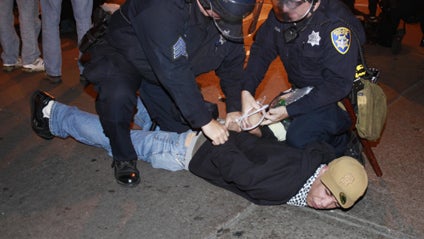 Police hold a demonstrator in Oakland, Calif., after a guilty verdict for Johannes Mehserle, Thursday, July 8, 2010.  