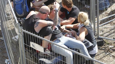 Collapsed people get first aid after a panic on this year's techno-music festival "Loveparade 2010" in Duisburg, Germany, on Saturday, July 24, 2010. 