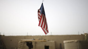 A U.S. flag hangs from the roof of COP Nolen, in the volatile Arghandab Valley in Kandahar, Afghanistan, Saturday, July 24, 2010.  