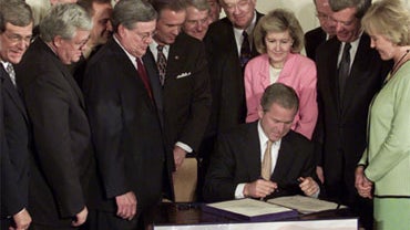 President Bush signing his $1.35 trillion tax cut bill, June 7, 2001 at the White House.  